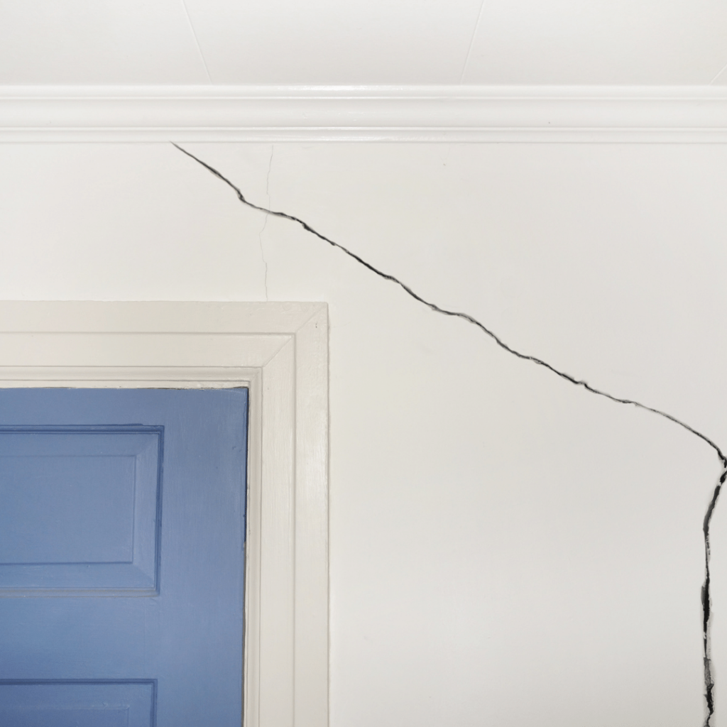 Diagonal cracks near door and window frames coupled with sloping  is a cause for worry. 