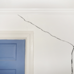 Diagonal cracks near door and window frames coupled with sloping  is a cause for worry. 